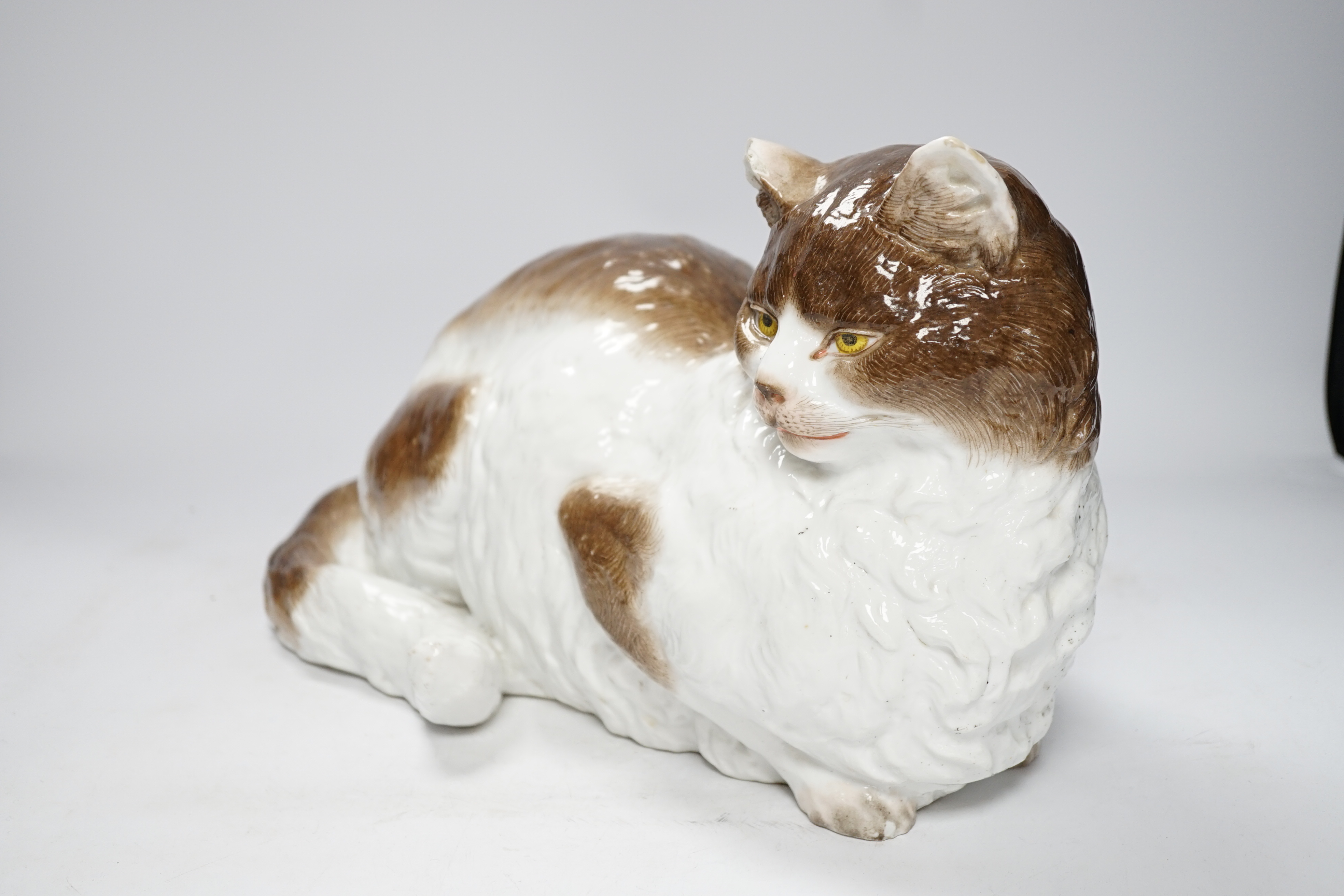 A large Meissen style figure of a seated cat, pseudo crossed swords mark to the base, 37cm wide
